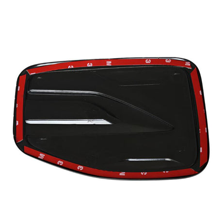 A black, rectangular car accessory with aerodynamic grooves and adhesive backing, featuring red 3M tape along the edges.