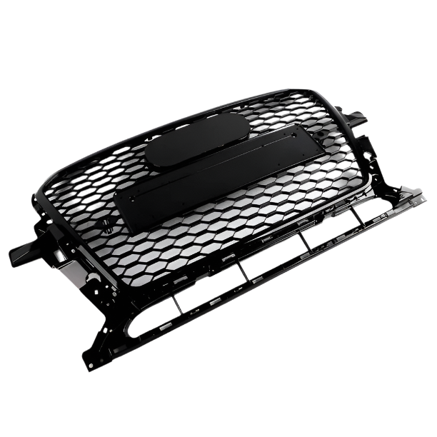 A black honeycomb car grille rests on a white background, featuring an oval emblem space above a rectangular mounting bracket, with supporting frame edges visible.