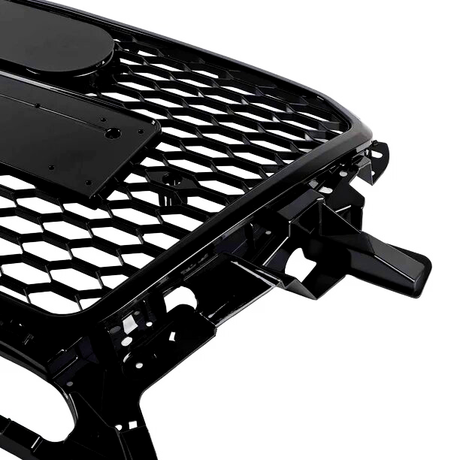 A black car grille with a honeycomb pattern and mounting brackets is positioned against a white background.