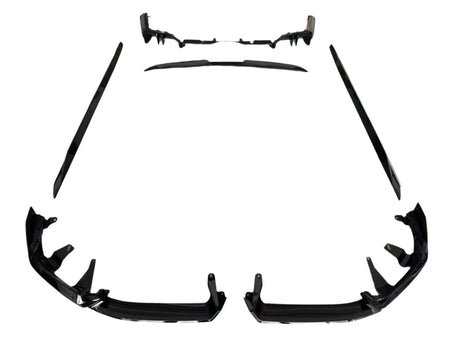 Individual black car body kit components are arranged symmetrically on a white background, including bumper pieces, side skirts, and a rear diffuser, designed for vehicle enhancement and protection.