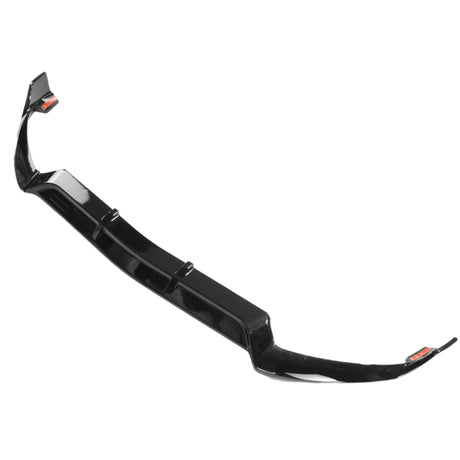 A black car front splitter lies on a white background. It features a glossy finish and has aerodynamic curves at the edges for performance enhancement.