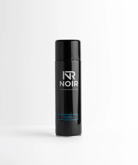 A black aerosol can stands upright on a white surface. It features text reading, "NR NOIR," "High Pressured Deodoriser," and "BLEU" in blue. The background is plain white.