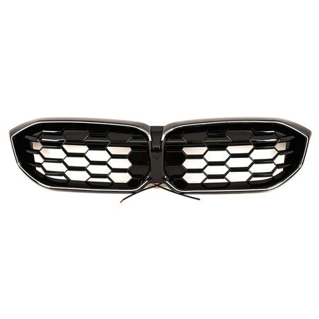 A black car grille with honeycomb design, featuring two separate sections joined in the center. Wires protrude from the middle, suggesting electronic integration. The background is plain white.