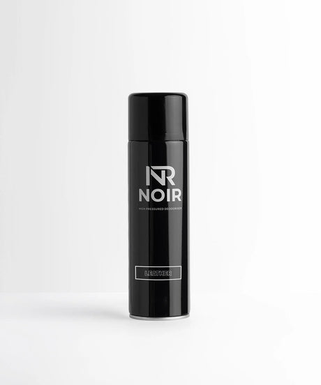 Black aerosol can standing upright on a white surface, labeled "NR Noir" and "High Pressured Deodoriser" with "Leather" in a box below, against a plain white background.