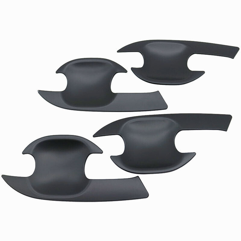Four black, curved plastic door handle covers are arranged on a plain white background. Each cover features a cutout design, tailored to fit vehicle door handles.
