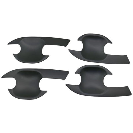 Four black, curved, plastic car door handle covers are positioned symmetrically on a plain background. They have an ergonomic design with cutouts for easy installation.