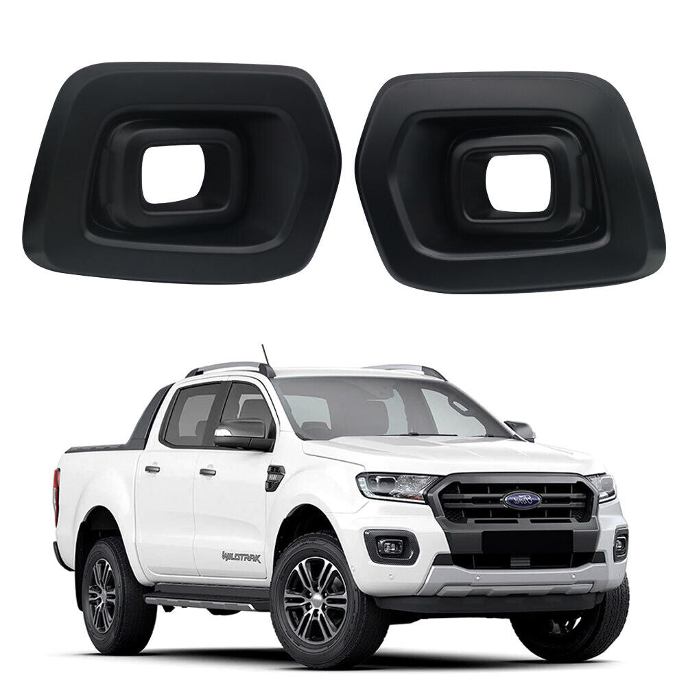 Two black plastic fog light covers are displayed above a white pickup truck with a modern design, parked on a plain white background.