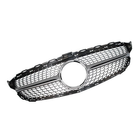 A hexagonal car grille with silver trim and a central circular emblem space is placed against a plain white background, highlighting its sleek design and mesh pattern.