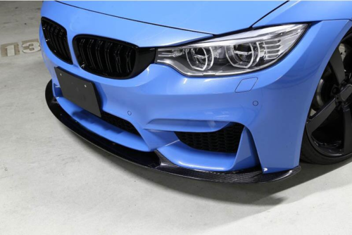 A blue sports car, with a carbon fiber front splitter and detailed headlights, is parked in a garage. The floor is marked with "P3."