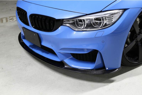 A blue sports car, with a carbon fiber front splitter and detailed headlights, is parked in a garage. The floor is marked with "P3."