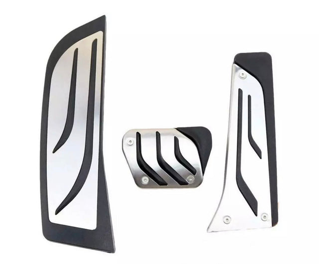 Three metal car pedal covers, featuring sleek black accents and a modern design, are arranged on a plain white background.