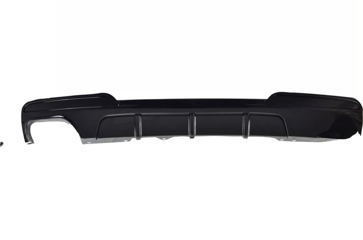 A black car bumper, featuring vertical slits for airflow, is displayed against a plain white background.