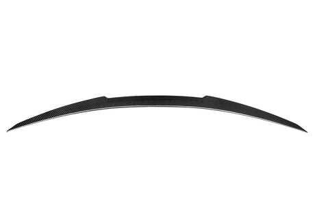 Curved carbon fiber car spoiler resting in a plain white background. The spoiler features a sleek, streamlined design and symmetrical tapering at both ends.