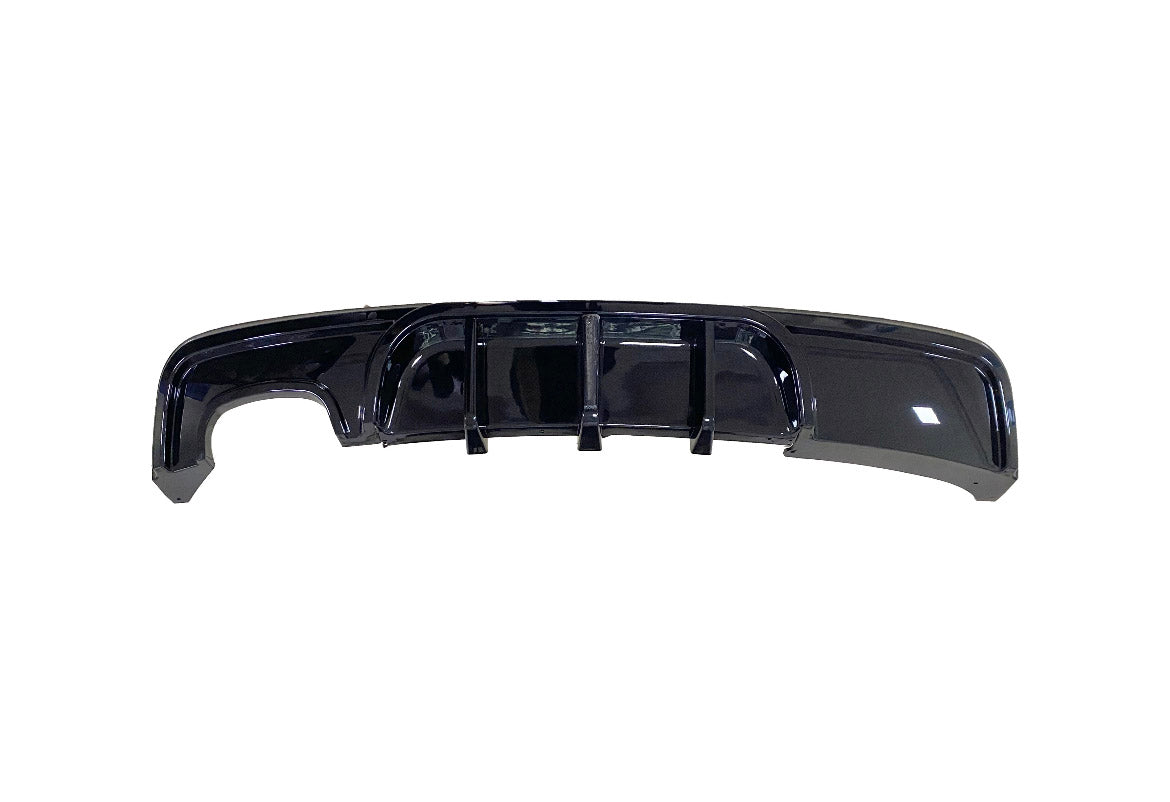 A glossy black car rear diffuser featuring vertical fins is displayed against a plain white background.