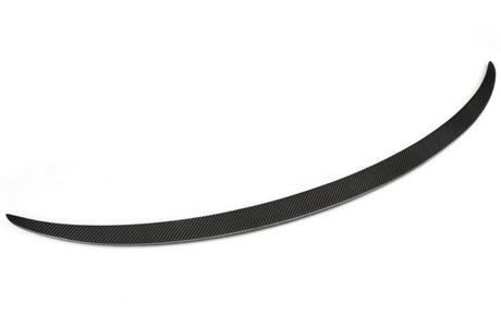 A sleek, curved black carbon fiber spoiler blade rests on a white background, showcasing a finely textured surface with diagonal patterns, designed to enhance vehicle aerodynamics.