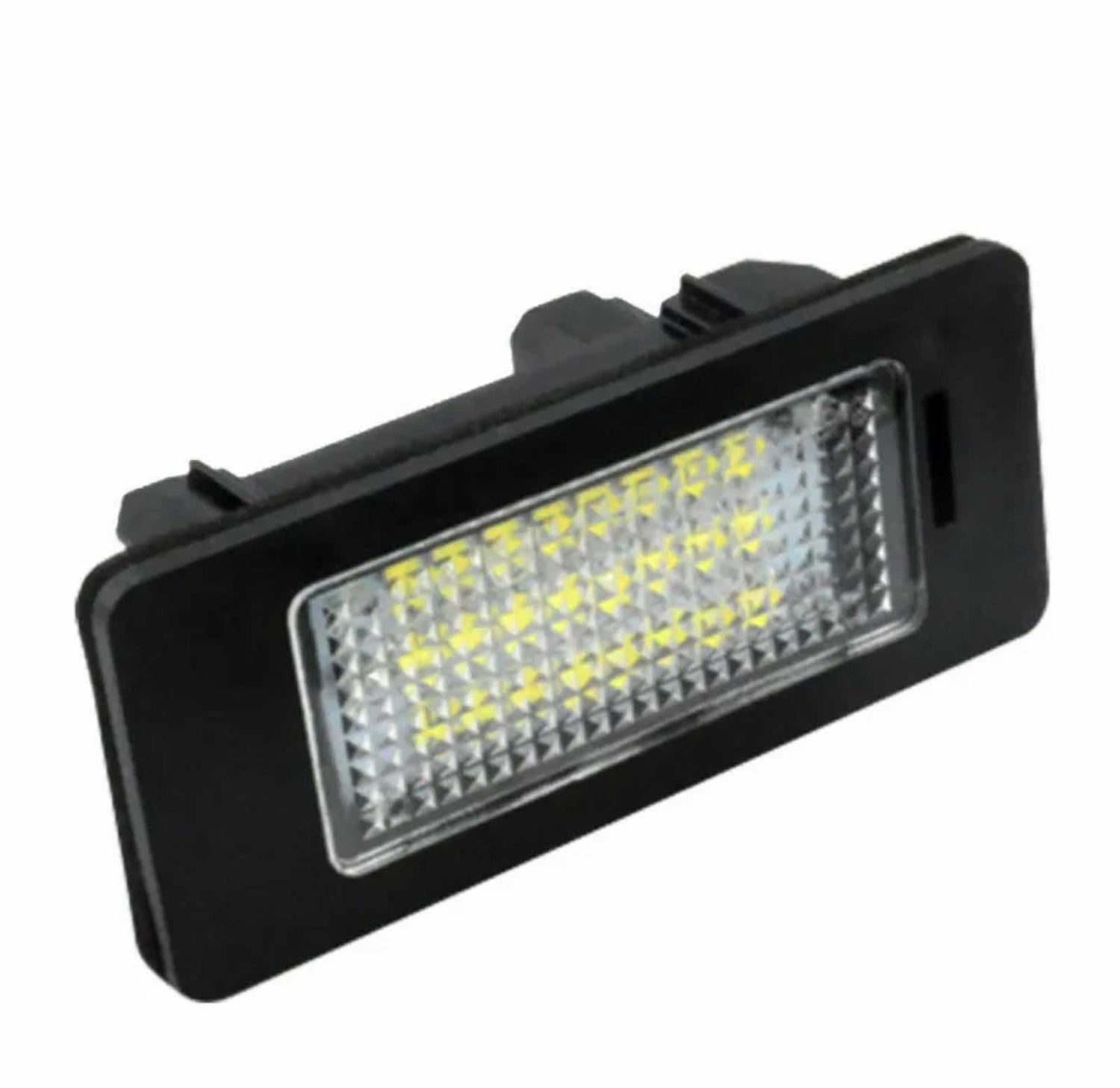 A rectangular LED light with a black casing emits a bright glow from a grid of yellow lights, designed for automotive use, isolated on a simple white background.