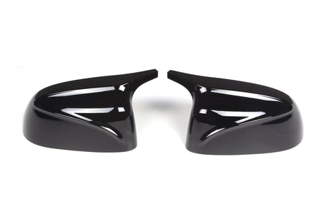 Two glossy black side mirror covers positioned symmetrically, facing each other against a white background, designed for automotive use.