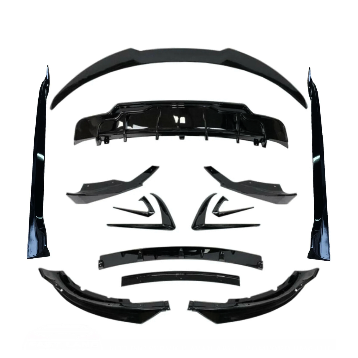Various black car body kit components, including spoilers and diffusers, arranged symmetrically on a white background, showcasing their design and shape for automotive customization.