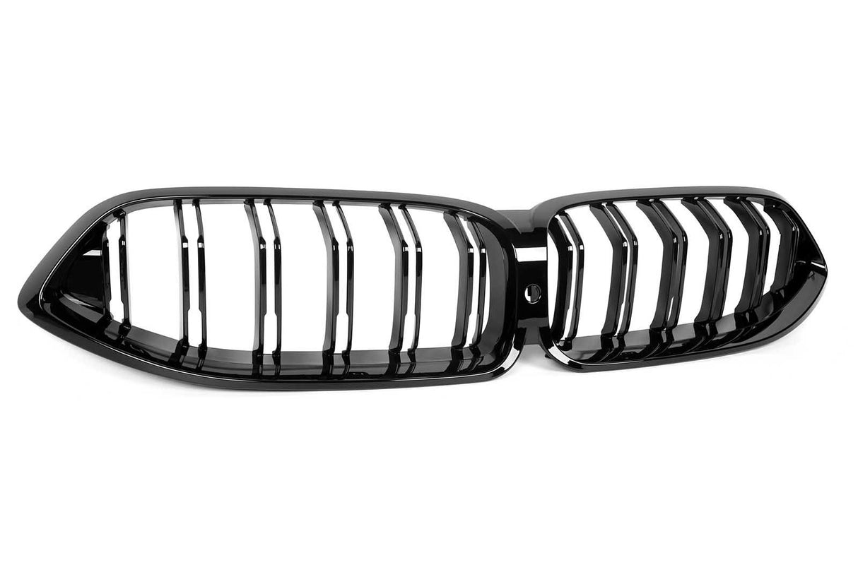 A black car front grille with vertical slats, featuring a kidney-shaped design. It rests on a plain white background, highlighting its glossy finish and sleek appearance.