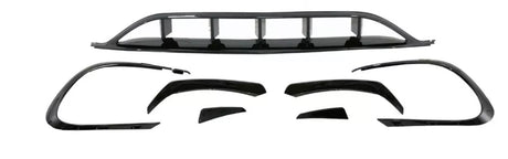 Car body kit components are arranged on a white background, including bumper covers and aerodynamic trim pieces, all in shiny black, designed to enhance vehicle appearance and performance.