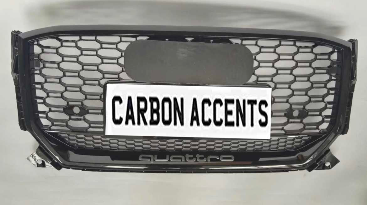 Grille with honeycomb pattern displayed on a light background. It features text "CARBON ACCENTS" on a license plate, with "quattro" written below in smaller lettering.