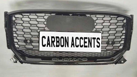 Grille with honeycomb pattern displayed on a light background. It features text "CARBON ACCENTS" on a license plate, with "quattro" written below in smaller lettering.