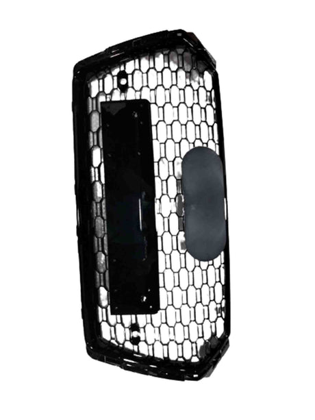 Hexagonal-patterned car grille with a rectangular and oval attachment, positioned vertically against a plain, white background.