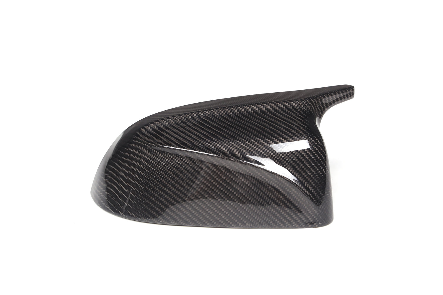 A glossy, carbon fiber car side mirror cover is positioned against a plain white background. It features a textured pattern typical of carbon fiber materials, showcasing aerodynamic design.