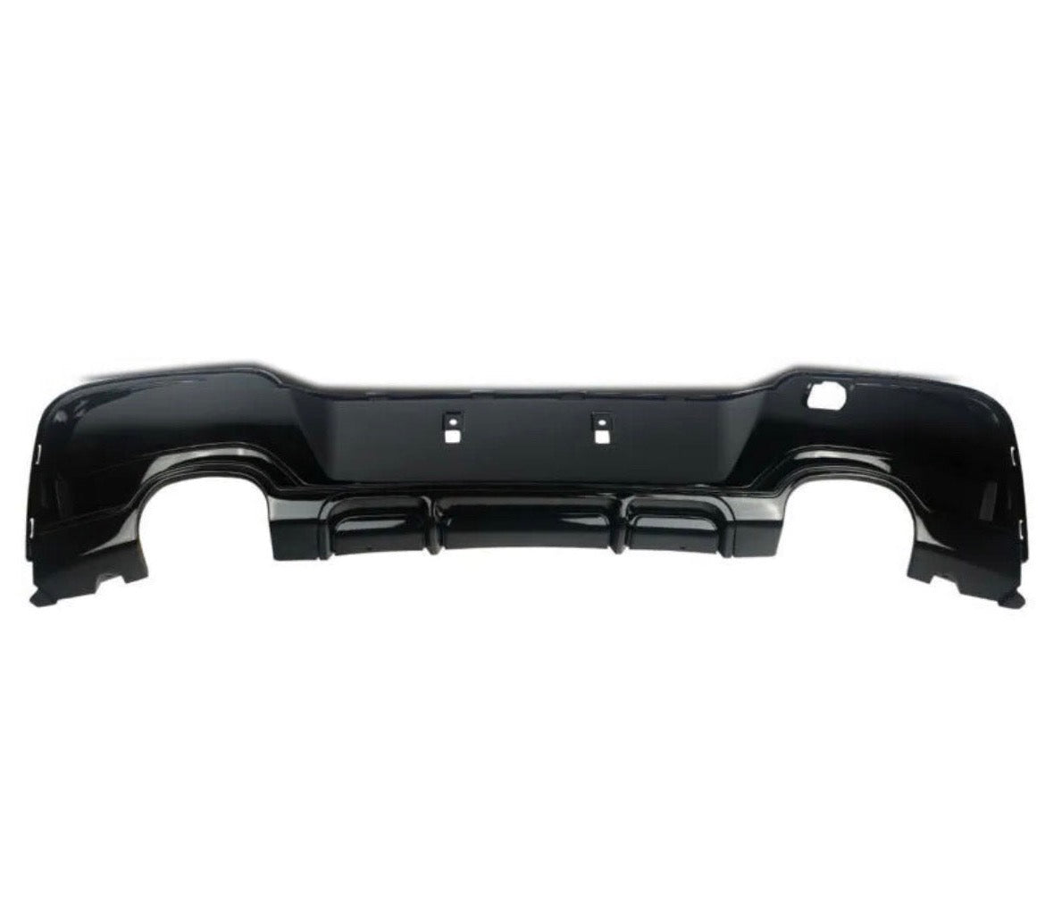 A black car bumper, detached, is displayed against a plain white background, showcasing its sleek design and mounting points.