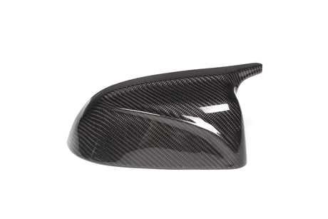 Carbon fiber side mirror cover, glossy and textured, positioned on a plain white background.