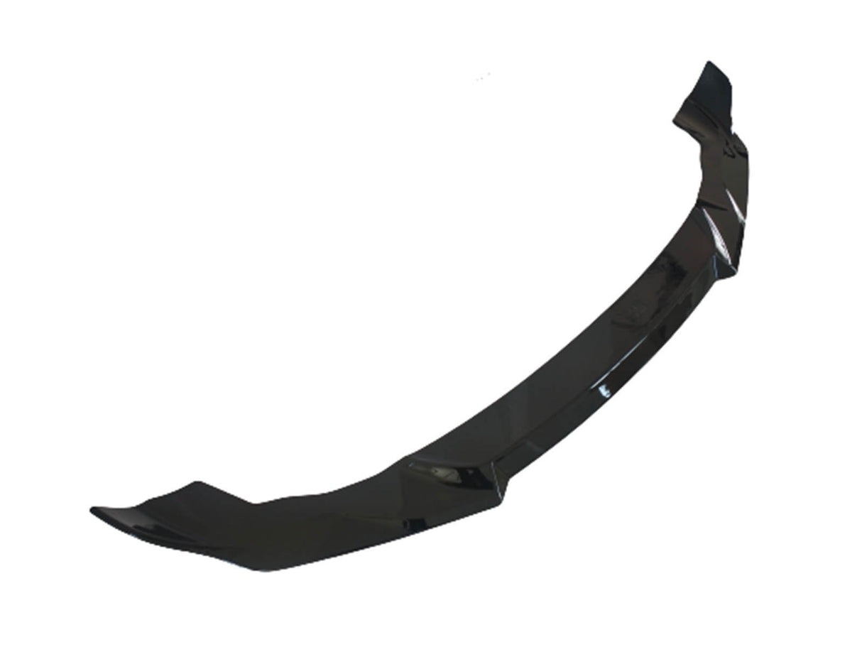 A glossy black car front splitter, designed to enhance aerodynamics, lies against a plain white background.
