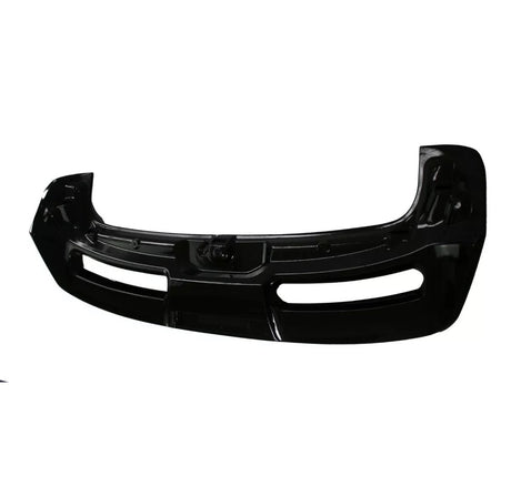 A black car bumper rests upright on a plain white background, featuring two rectangular cutouts and a sleek, curved design.