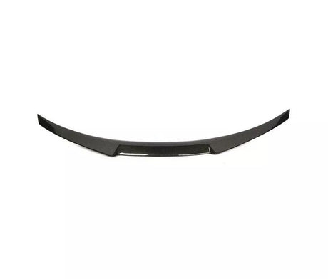 Curved, black carbon fiber car spoiler with a sleek design, resting against a plain white background.