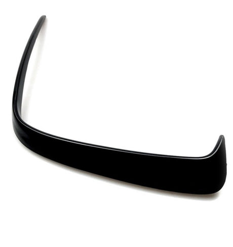 A black, curved car spoiler sits against a plain white background, highlighting its smooth, aerodynamic shape designed for enhancing vehicle performance.