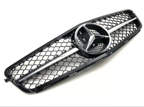 A black car grille features a central silver emblem with three pointed stars, bordered by a mesh pattern against a plain white background.