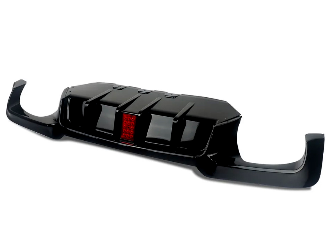 A black car rear diffuser with aerodynamic fins and a central red reflector, designed for enhancing vehicle performance, shown isolated against a plain white background.