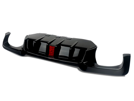 A black car rear diffuser with aerodynamic fins and a central red reflector, designed for enhancing vehicle performance, shown isolated against a plain white background.
