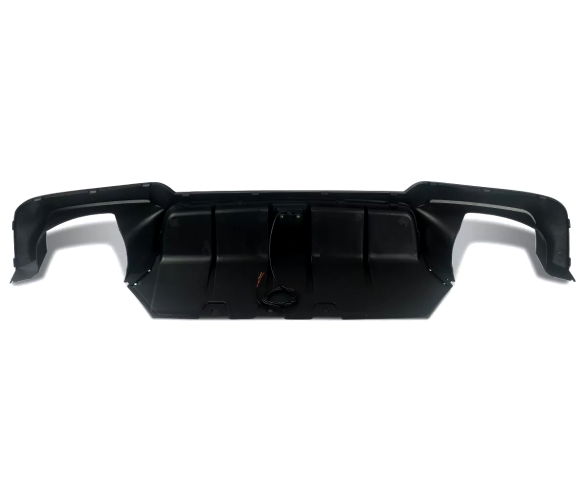 A black car bumper with integrated wiring rests on a white background, showcasing its sleek, contoured design and aerodynamic features.