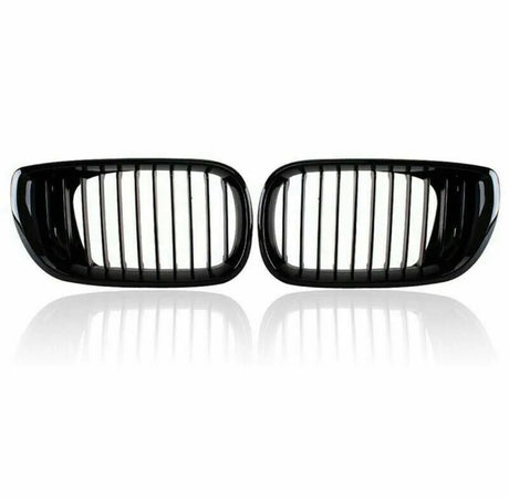 Two black car kidney grilles with vertical slats are shown against a plain white background, reflecting slightly underneath, suggesting a glossy surface.