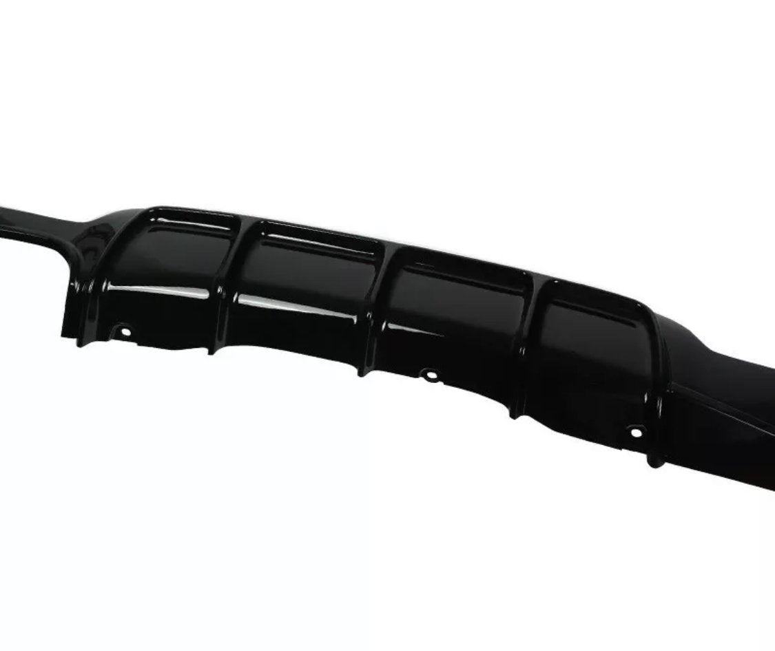 A black, glossy car bumper with six curved sections features mounting holes. It's positioned against a plain, white background, indicating it is a standalone product image.