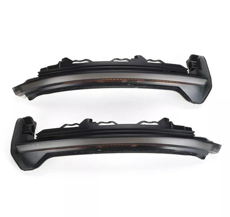 Two dark, sleek car LED rearview mirror indicators are parallel, displaying a modern design. The context is a plain white background, highlighting the components' structure.