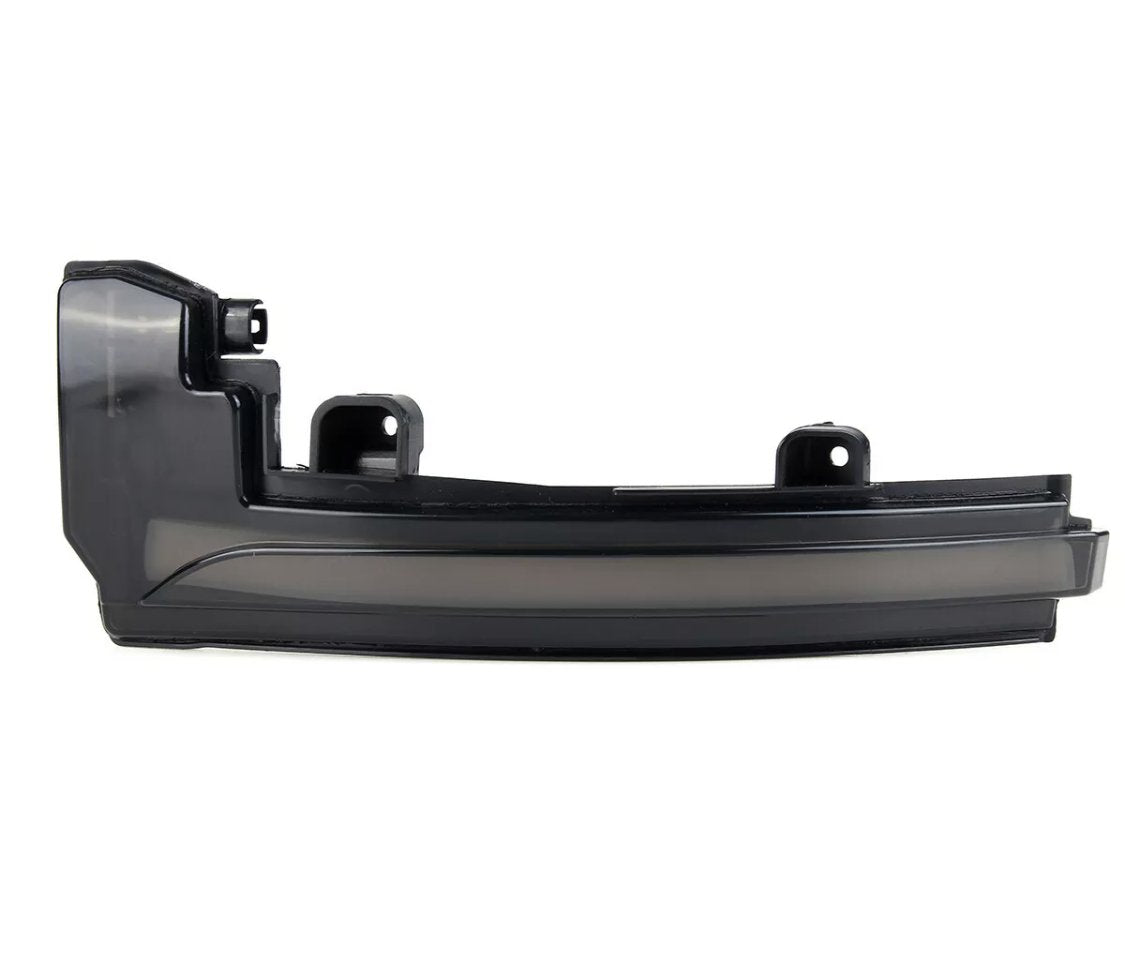 A black car component, possibly a side mirror turn signal cover, is displayed on a plain white background, featuring mounting brackets and a sleek, curved design.