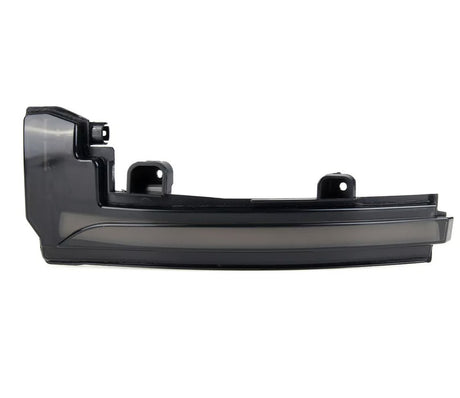 A black car component, possibly a side mirror turn signal cover, is displayed on a plain white background, featuring mounting brackets and a sleek, curved design.