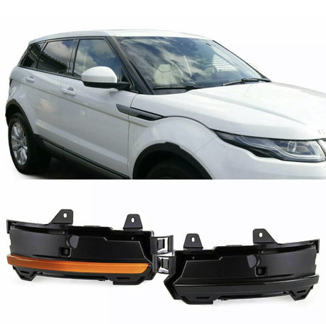 A white SUV is parked, reflecting a cloudy sky on its windows. Below are two black and orange car parts, likely fog light covers, against a white background.