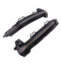 Two curved black plastic car mirror covers with integrated LED turn signals lie against a plain white background, showcasing openings and connectors for installation.