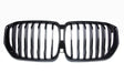 A shiny black car grille with vertical slats, forming two adjacent kidney-shaped sections, set against a plain white background.