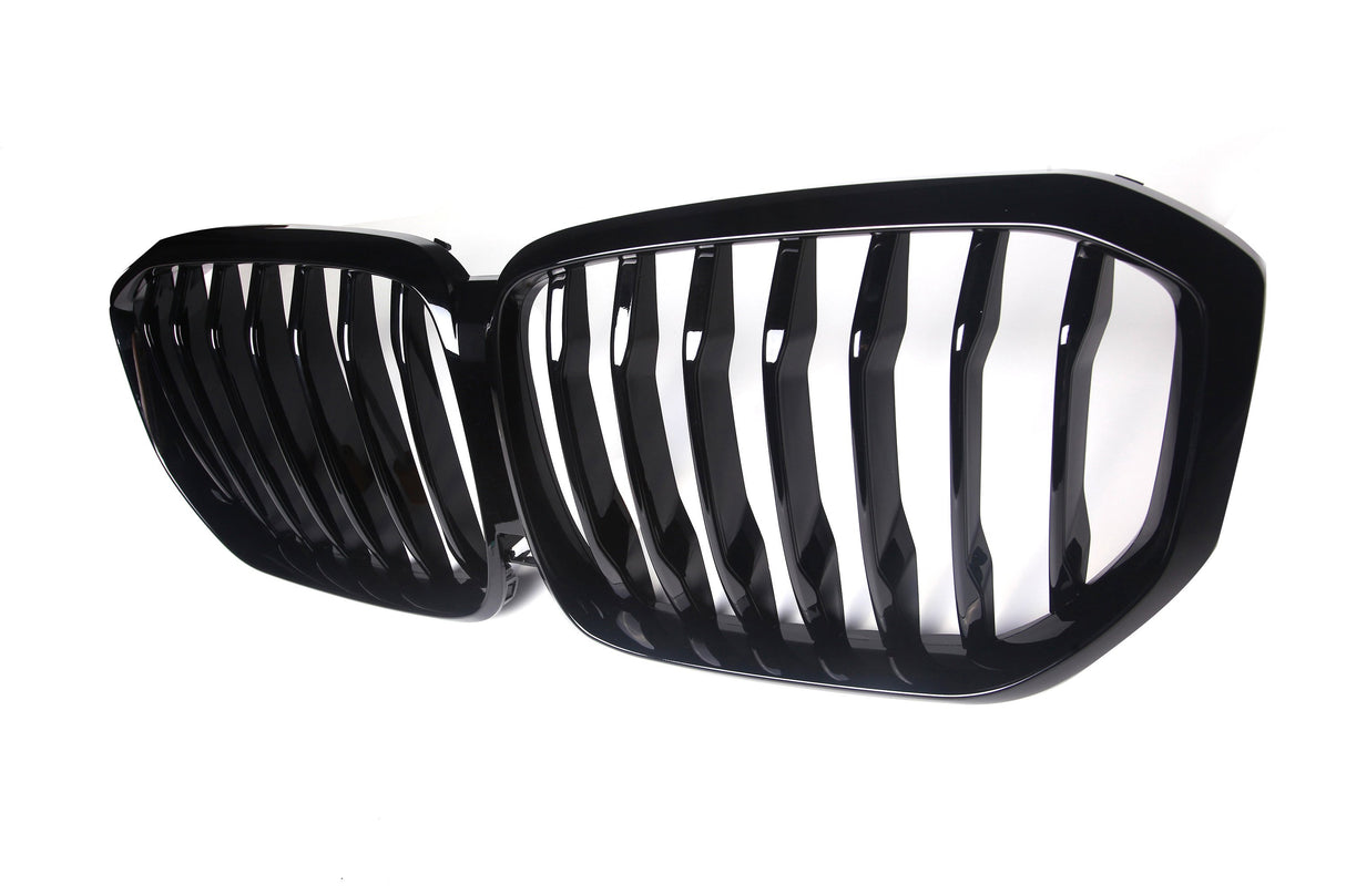 A black grille with vertical slats is positioned side-by-side, designed for a vehicle's front. It is set against a plain white background, emphasizing its shiny finish.