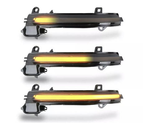 Three sequentially lit amber LED strips, mounted in black plastic casings, appear aligned vertically against a white background; they resemble automotive indicator lights.