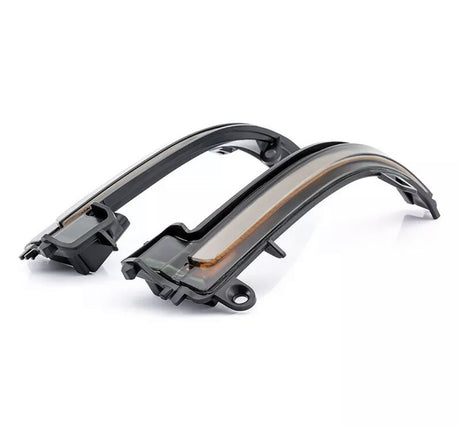 Two black, curved LED turn signal lights for a vehicle, resting side-by-side on a plain white background, with a sleek design and translucent covering.