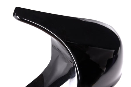 A sleek, shiny black stiletto heel with a pointed tip stands isolated against a plain white background.